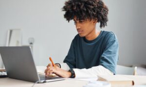 young man studying for competency test to find a dialysis tech job